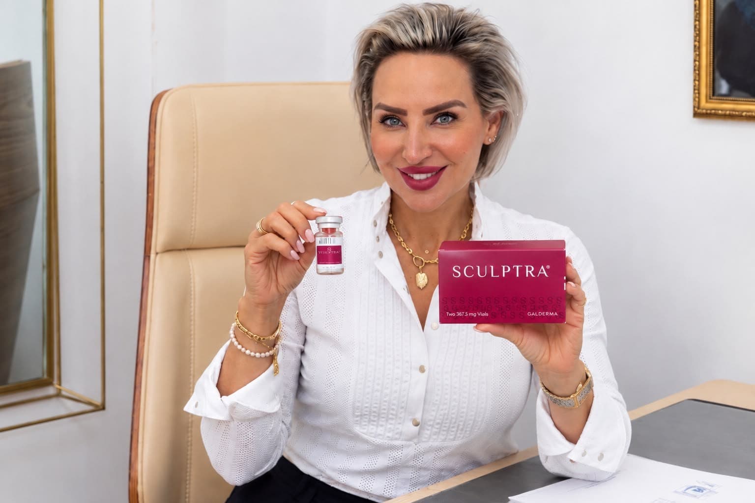 Sofia holding a Sculptra vial and box at YourHealthFirst Clinic